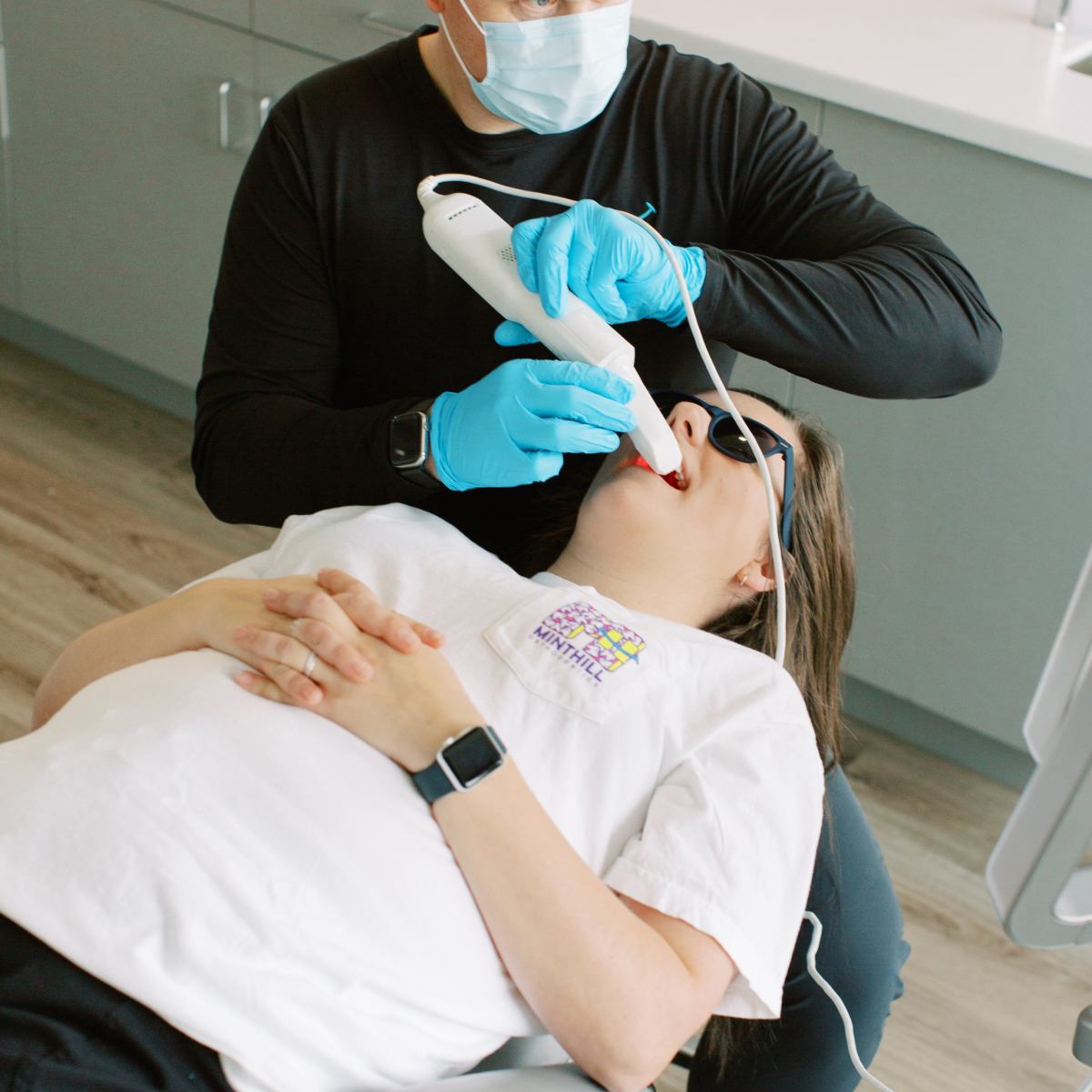 Orthodontist scanning patient's teeth